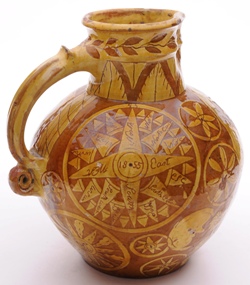 a north devon pottery harvest jug showing typical scroll terminal and thumrest